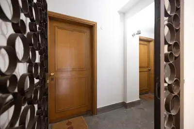 a hallway with a door and a wall of wine racks at Romantic Refuge in Piazza Navona in Rome