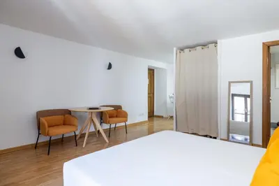 a bedroom with a bed and a table and chairs at Romantic Refuge in Piazza Navona in Rome