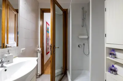a white bathroom with a sink and a shower at Romantic Refuge in Piazza Navona in Rome