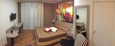 a small bedroom with a bed and a mirror at B&B Le Vibrazioni in Rome