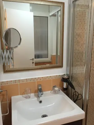 a bathroom with a white sink and a mirror at B&B Le Vibrazioni in Rome