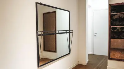 a mirror hanging on a wall in a room at Roman Forum Rooms in Rome