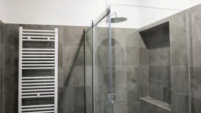 a shower with a glass door in a bathroom at Roman Forum Rooms in Rome