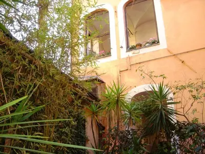 a building with potted plants on the side of it at Apartment in Rome-Trastevere - Amorhome in Rome