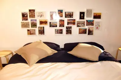 a bedroom with a bed with pictures on the wall at Apartment in Rome-Trastevere - Amorhome in Rome