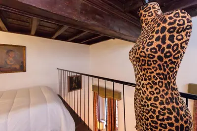 a statue of a leopard standing next to a bed at Apartment in Rome-Trastevere - Amorhome in Rome