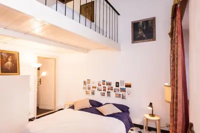 a bedroom with a bed and a staircase at Apartment in Rome-Trastevere - Amorhome in Rome