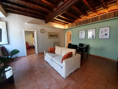 a living room with a white couch and a table at Laterano Home in Rome