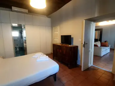 a bedroom with a bed and a tv and a couch at Laterano Home in Rome