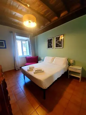 a bedroom with a large white bed in a room at Laterano Home in Rome