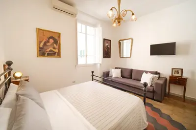 a living room with a couch and a tv at Vatican Domus by BuddyRent in Rome