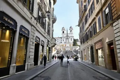 a group of people walking down a street with buildings at Residenza Nobile Vittoria in Rome