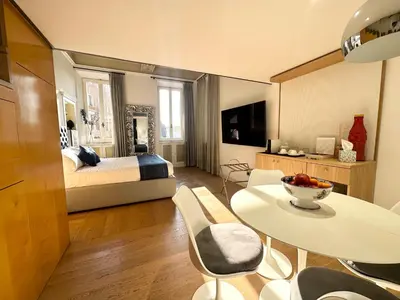 a bedroom with a bed and a table and chairs at Residenza Nobile Vittoria in Rome