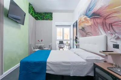 a bedroom with a bed and a painting on the wall at Le Regine - Home suites - Adult Only in Rome