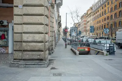 a city street with buildings and a person riding a bike at Le Regine - Home suites - Adult Only in Rome