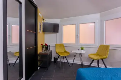 a room with two yellow chairs and a table at Le Regine - Home suites - Adult Only in Rome