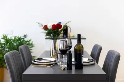 a dining room table with wine bottles and glasses at Suite & Outdoor Patio - Colosseum & Fori Imperiali in Rome