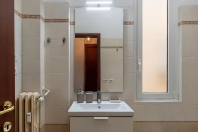a bathroom with a white sink and a mirror at GuestHost - Close to St Peter in Rome