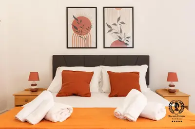 a bedroom with a bed with orange and white pillows at Dream House Re di Roma - 50mt to Metro Station, central position, 4pax, 2bdr in Rome