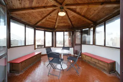 a room with a table and chairs and windows at Monti's View by BuddyRent in Rome