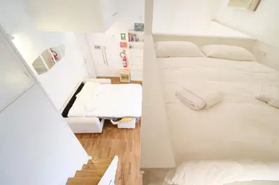 a small room with a bed and a staircase at Monti's View by BuddyRent in Rome