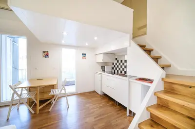 a kitchen and dining room with a staircase and a table at Monti's View by BuddyRent in Rome
