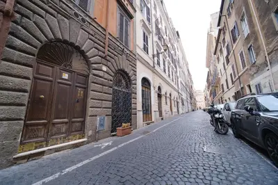 a street with a car parked next to a building at Monti's View by BuddyRent in Rome