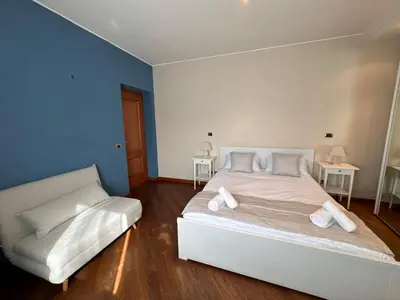a bedroom with a white bed and a white couch at Vatican District, Roma, alloggio centrale in Rome
