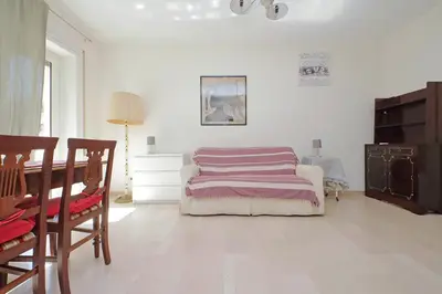 a bedroom with a bed and a table and chairs at Vatican Francy's House - San Pietro Rome in Rome