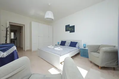 a white living room with a couch and a chair at Vatican Francy's House - San Pietro Rome in Rome