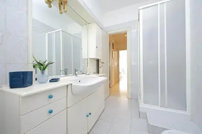 a white bathroom with a sink and a shower at Vatican Francy's House - San Pietro Rome in Rome