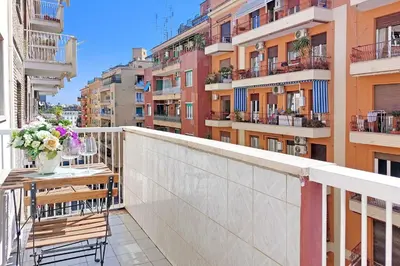 a balcony with a table and chairs and buildings at Vatican Francy's House - San Pietro Rome in Rome