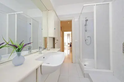 a white bathroom with a sink and a shower at Vatican Francy's House - San Pietro Rome in Rome