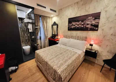 a hotel room with a bed and a mirror at Venus Inn Vatican Guest House in Rome