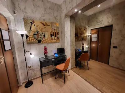 a room with a desk with a lamp and chairs at Venus Inn Vatican Guest House in Rome