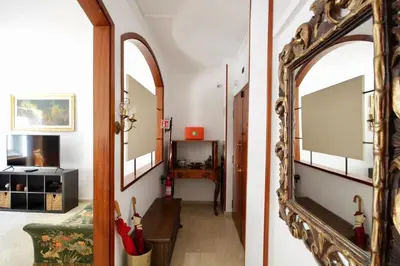 a hallway with an archway and a mirror at HC - Baldo degli Ubaldi Elegant Apartment in Rome