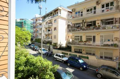a street with cars parked in front of a building at HC - Baldo degli Ubaldi Elegant Apartment in Rome