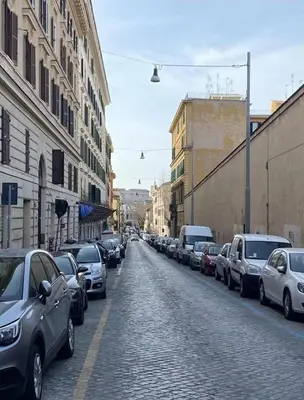 a street with cars parked on the side of a road at Cozy Colosseo in Rome