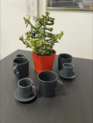 a group of cups and a potted plant on a table at Cozy Colosseo in Rome