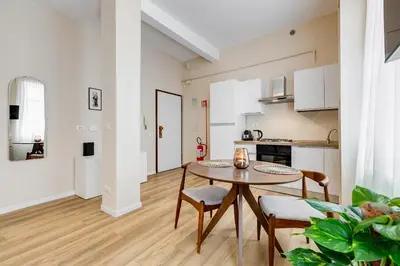 a kitchen and dining room with a table and chairs at Urbana 24 in Rome