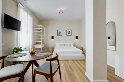 a bedroom with a bed and a table and chairs at Urbana 24 in Rome