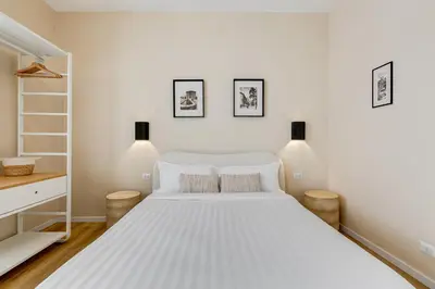 a bedroom with a large white bed with two pillows at Urbana 24 in Rome