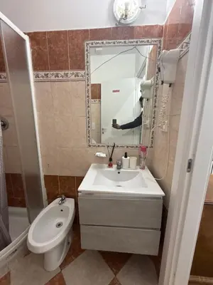 a bathroom with a sink and a toilet and a mirror at ROMA Classica in Rome
