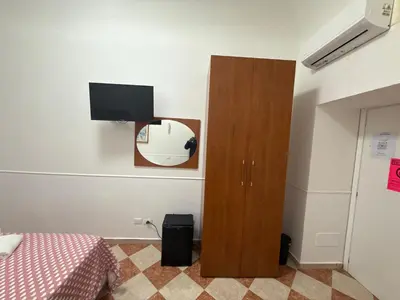 a bedroom with a bed and a tv on the wall at ROMA Classica in Rome