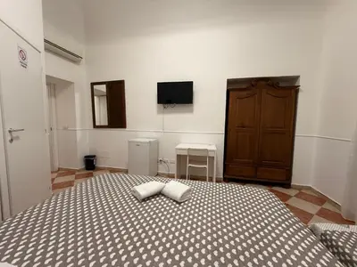 a bedroom with a bed with two pillows on it at ROMA Classica in Rome