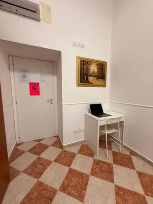 a room with a desk and a laptop on a table at ROMA Classica in Rome