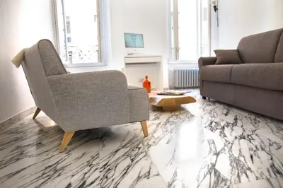 a living room with a couch and a chair at Abbituè Apartment in Rome