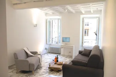 a living room with two couches and a table at Abbituè Apartment in Rome