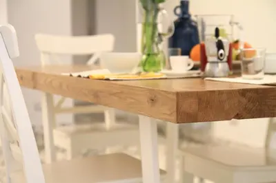 a wooden table with white chairs and a counter top at Abbituè Apartment in Rome