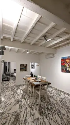 a dining room with a table and chairs at Abbituè Apartment in Rome